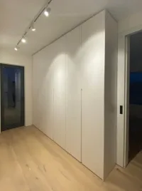 Customized wardrobe: a light white-colored wardrobe perfectly complements the warm wooden floor, creating a cozy atmosphere in our customer&rsquo;s bedroom in Zuzenhausen, Germany – RAL9003 matte lacquered with integrated handles.

Our customer&rsquo;s comment: The wardrobes are of very good quality and easy to assemble. We completely refurnished our house, but the wardrobes from this company were the best.

The exact measurements of this wardrobe are: 291 cm in width, 267 cm in height, and 45 cm in depth.