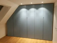 Sloping roof wardrobe: every roof has a different slope, so we offer our configurator, which adapts perfectly to your measurements to create a practical and functional design wardrobe customized to your needs. Everything is neatly enclosed behind personalized color doors. 

This wardrobe is installed in our customer’s house in Braunschweig, Germany - RAL Design 2406015 matte lacquered with integrated handles.