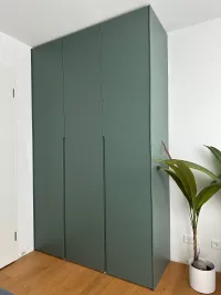 Customized wardrobe: Installed in our customer&rsquo;s guest/office bedroom in Munich, Germany, this green color shifts depending on the lighting conditions (daylight or artificial lighting).

With cool lighting in the room and reflections from the warm wood floor and white walls, it takes on a warmer green hue (as shown in the picture), creating a naturally bright and creative atmosphere for work.

This wardrobe is finished in FB 47 green smoke matte lacquer with integrated handles.